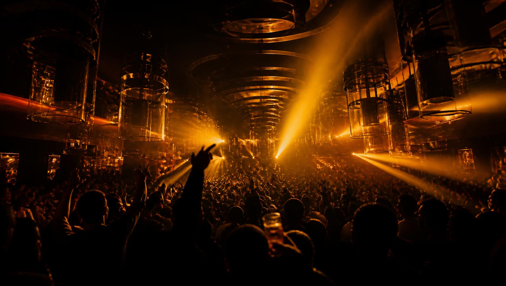Crowd under dramatic golden lighting inside Centro Nightclub Lawrence